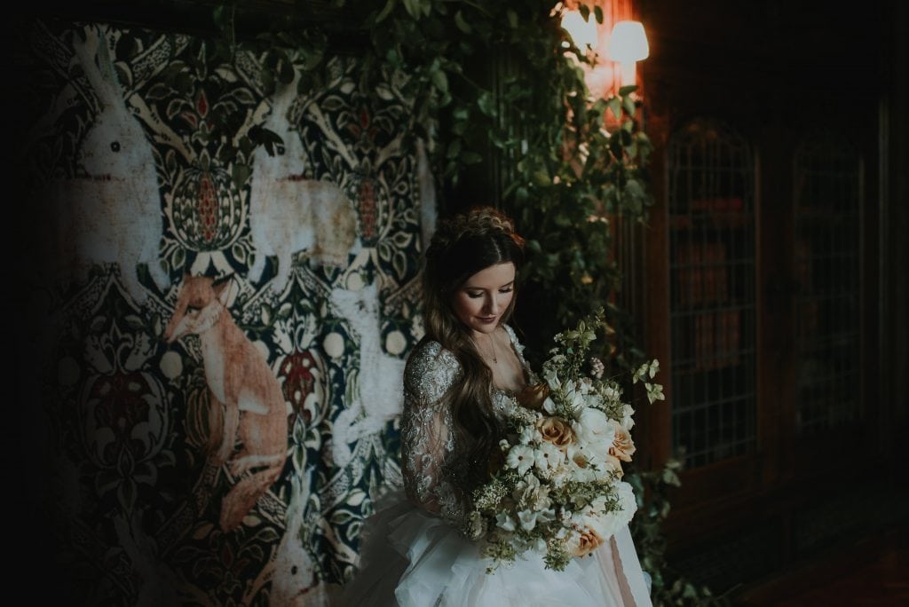 bride holding bouquet in an ornate mansion