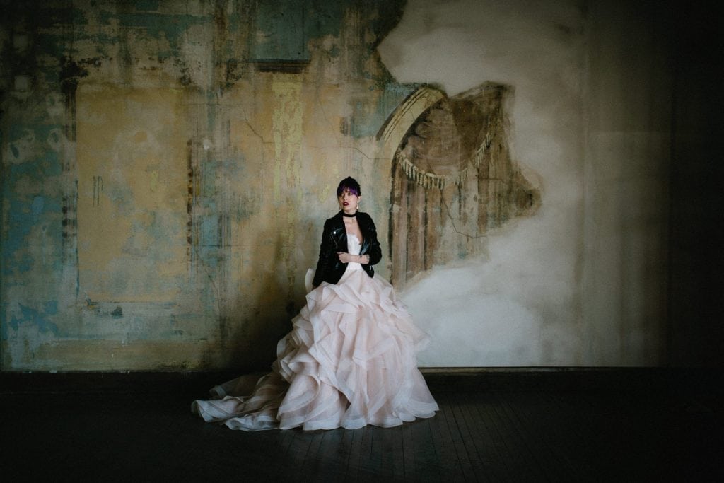 beautiful bride in pink gown with a leather jacket