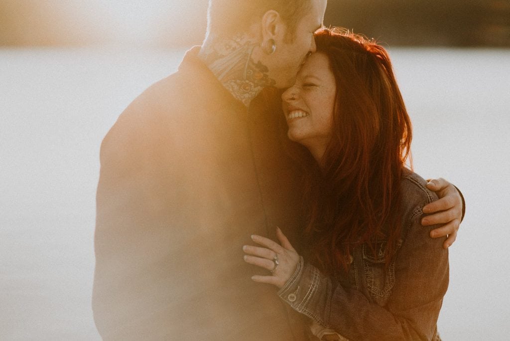 beautiful couple kissing at sunset