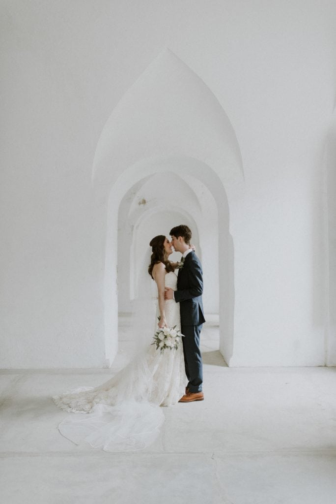 bride and groom laughing in a castle in puerto rico