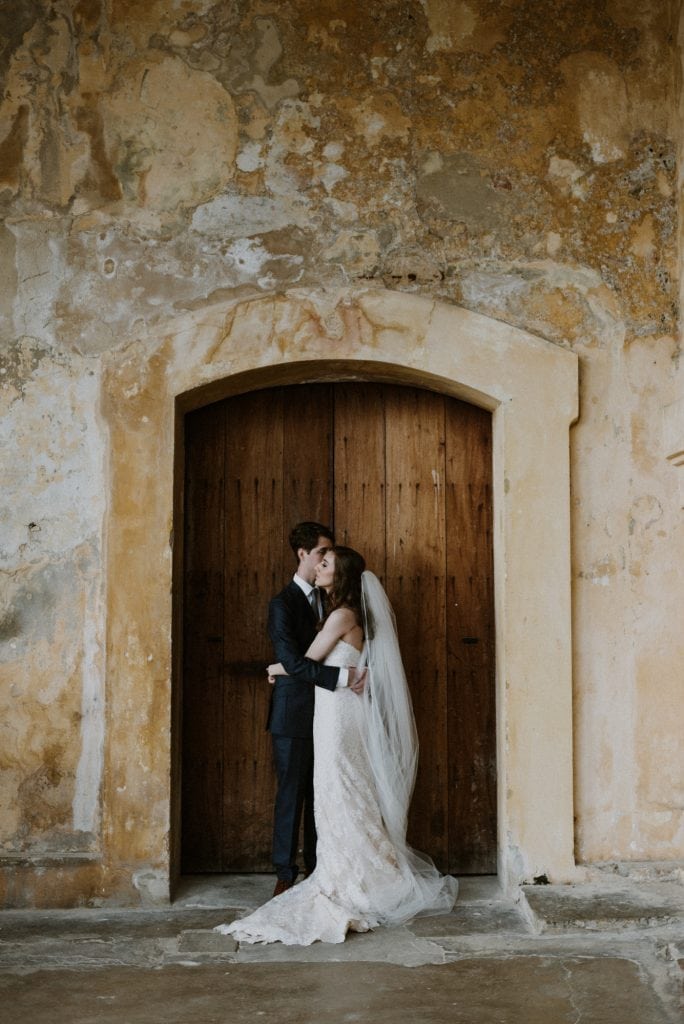 beautiful couple standing at a castle door