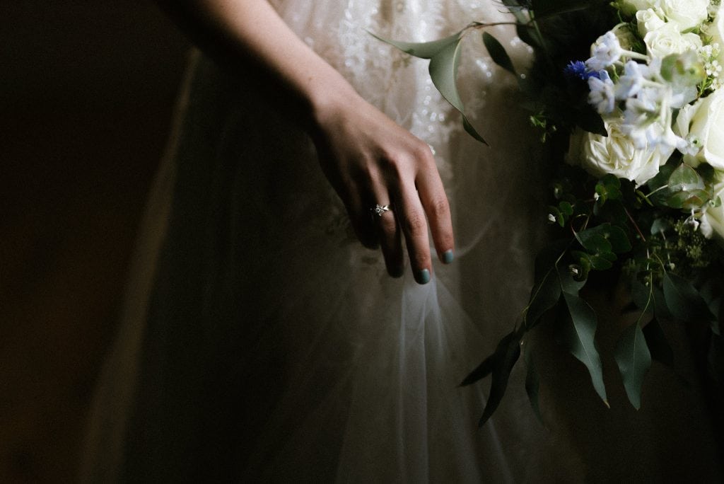 brides hand holding bouquet