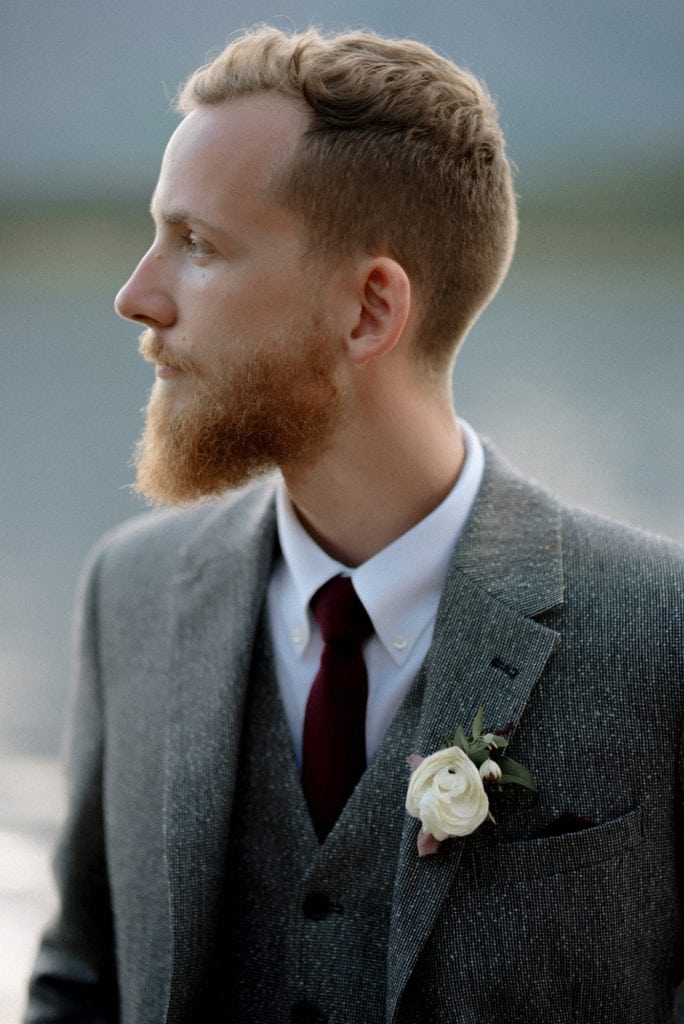 groom in gray suit and red tie